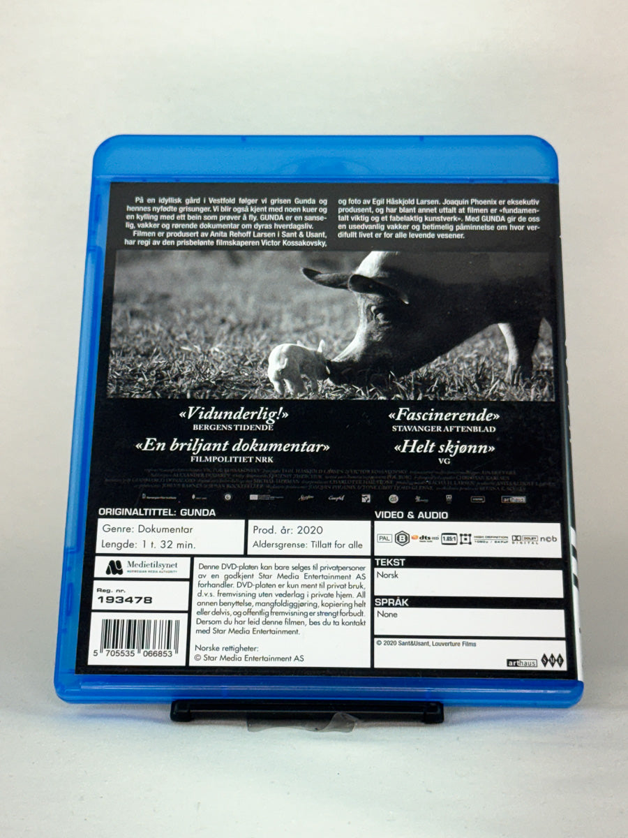 Bakside av Blu-ray-cover for Gunda – informasjon om dokumentaren og dens internasjonale suksess, brukt film hos Brukbar Film.