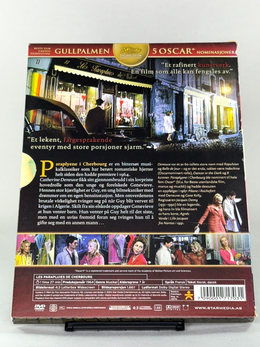 Bakside av DVD-cover til Paraplyene i Cherbourg – brukt filmklassiker på DVD, tilgjengelig hos Brukbar Film