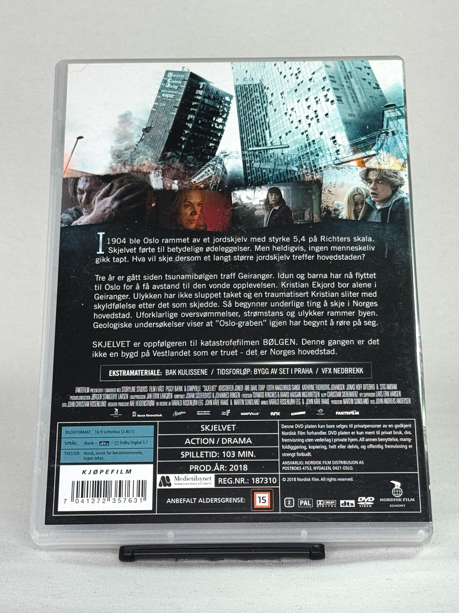 Bakside av DVD-cover til Skjelvet – oppfølger til Bølgen, norsk actiondrama om jordskjelv i Oslo, brukt film på DVD hos Brukbar Film