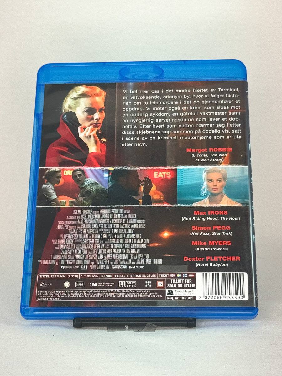 Bakside av Blu-ray-cover til Terminal – mørk og visuelt slående thriller med hevnmotiv, brukt Blu-ray hos Brukbar Film.