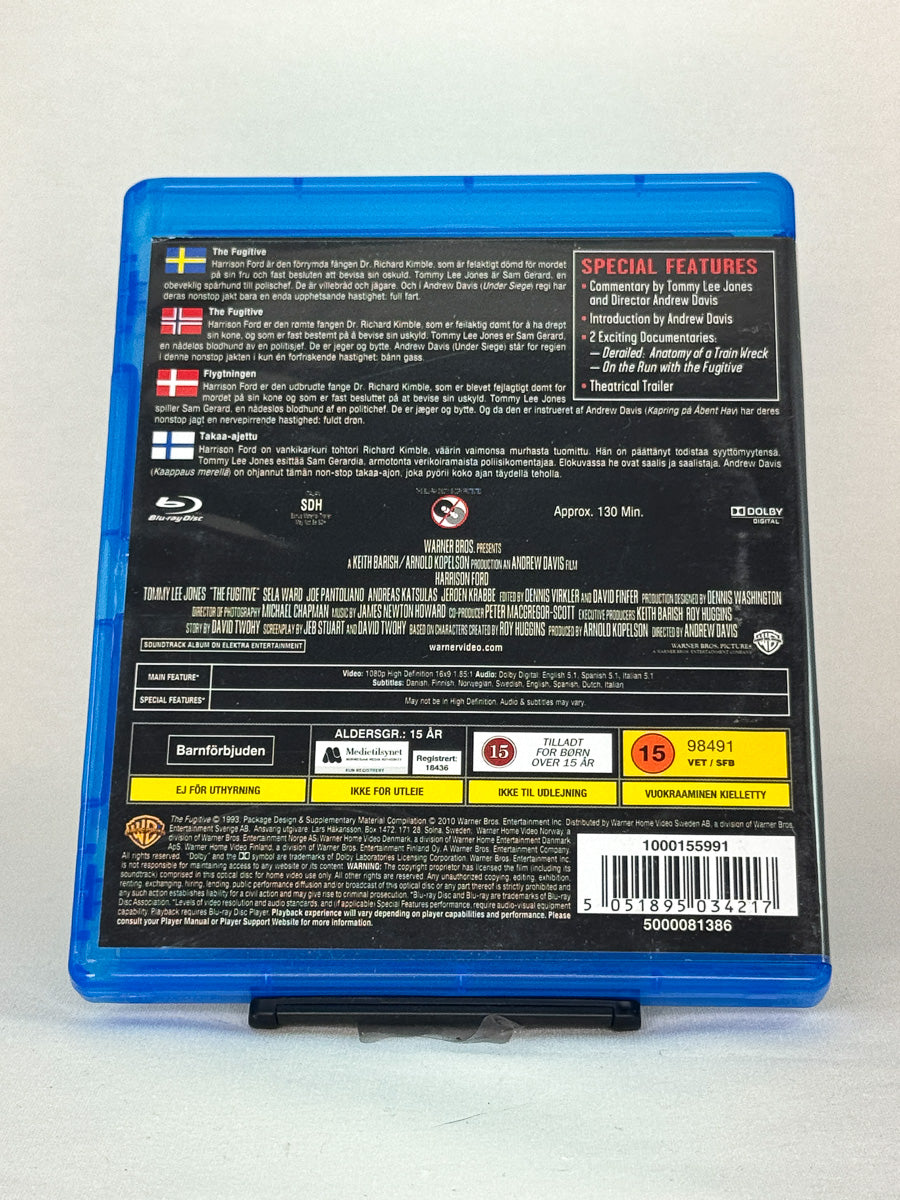 Bakside av Blu-ray-cover til The Fugitive – brukt originalfilm med intens jakt på uskyldig mann, tilgjengelig hos Brukbar Film