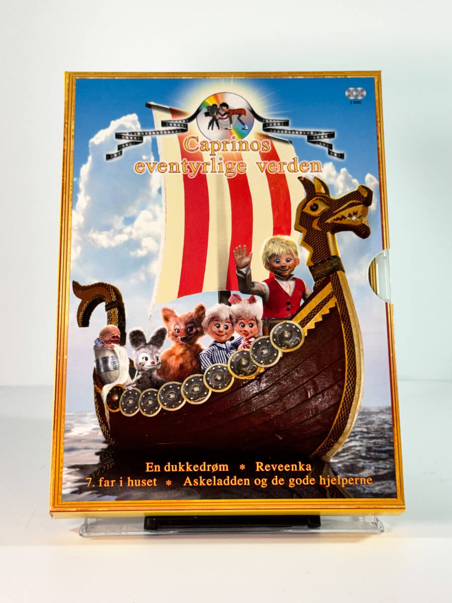 Forside av slipcase cover til caprinos eventyrlige verden – en dukkedrøm reveenka 7 far i huset askeladden og de gode hjelperne, brukt DVD hos Brukbar Film