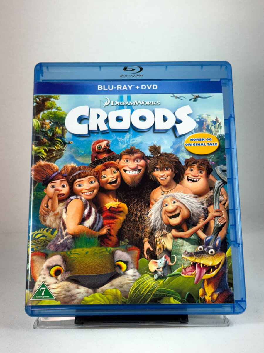 Forside av Blu-ray-cover til Croods – eventyrlig animasjonsfilm fra DreamWorks, norsk og original tale, brukt film hos Brukbar Film.