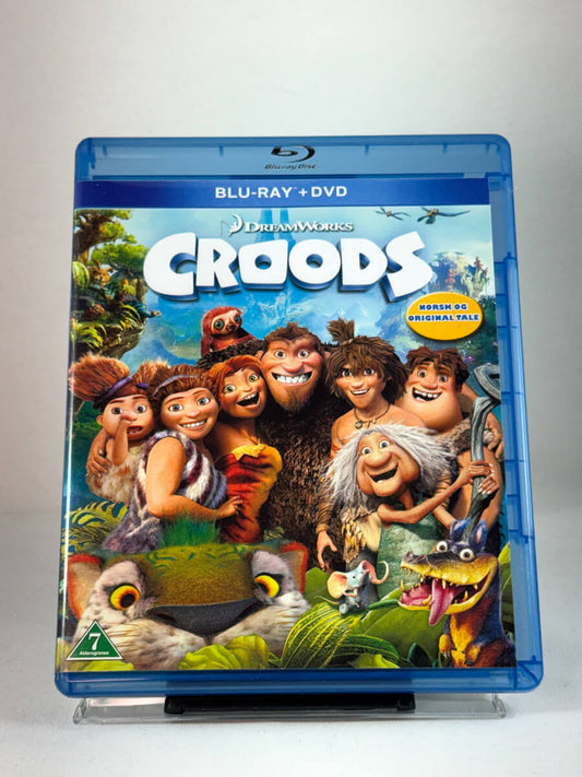 Forside av Blu-ray-cover til Croods – eventyrlig animasjonsfilm fra DreamWorks, norsk og original tale, brukt film hos Brukbar Film.