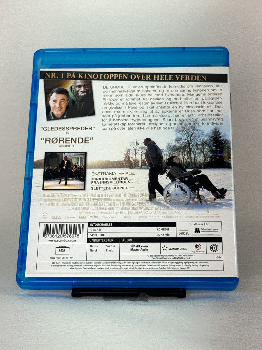Bakside av Blu-ray-cover for De urørlige (Intouchables) – brukt internasjonal publikumsfavoritt på Blu-ray fra Brukbar Film