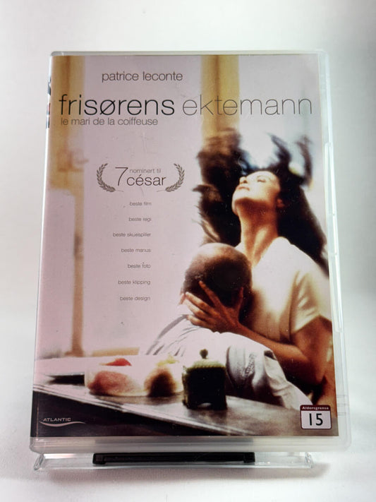 Forside av DVD-cover til Frisørens ektemann med romantisk dramasymbolikk; brukt europeisk dramafilm på DVD hos Brukbar Film