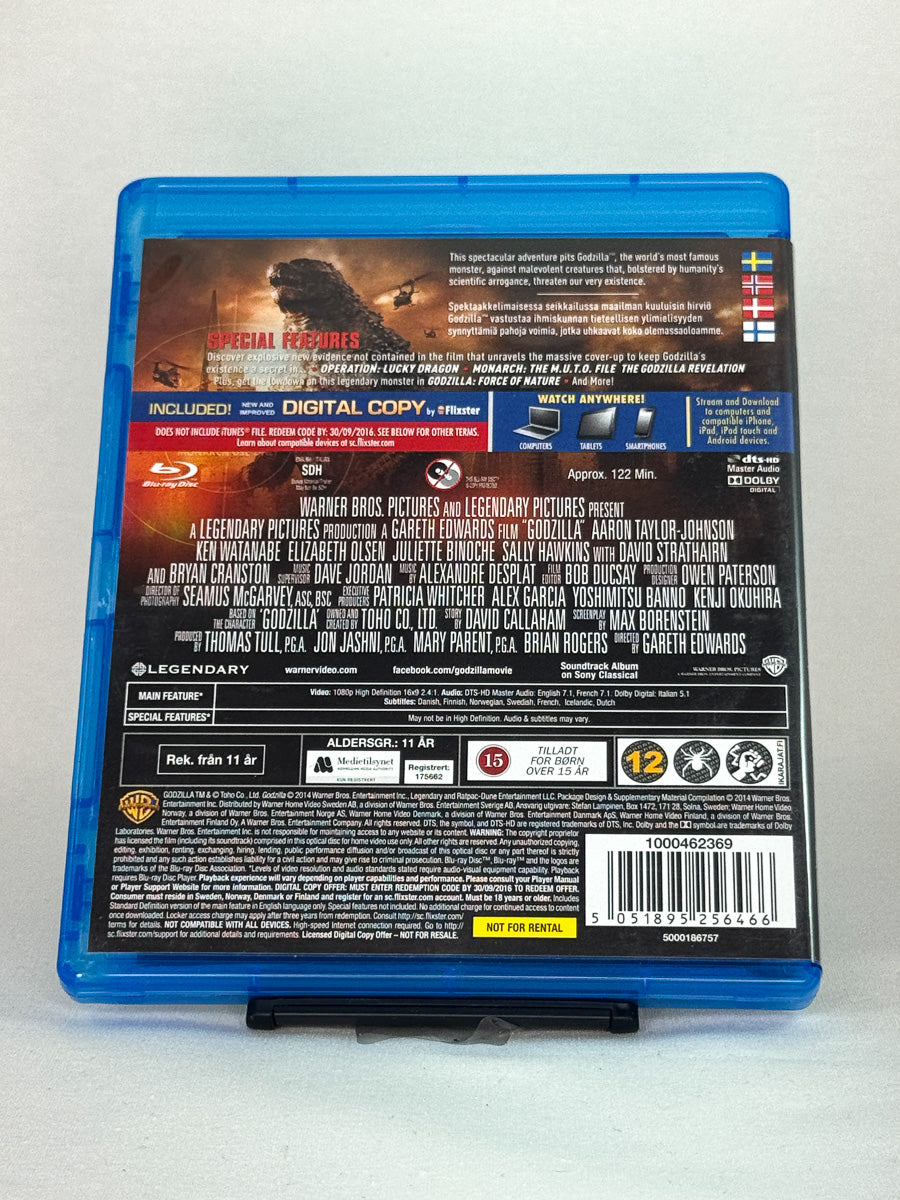 Bakside av Blu-ray-cover til Godzilla – eksplosiv nytolkning av filmmonsteret, regissert av Gareth Edwards, brukt Blu-ray hos Brukbar Film.