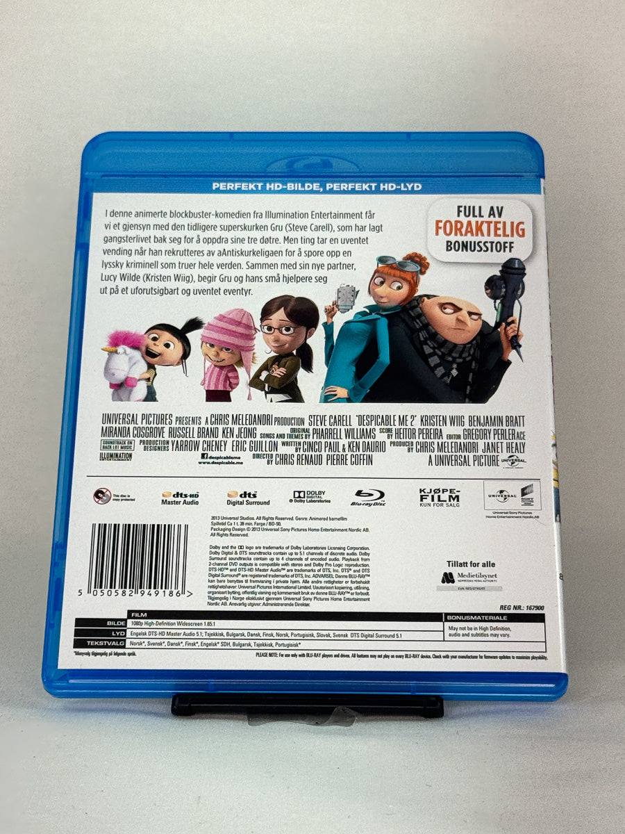 Bakside av Blu-ray-cover til Grusomme meg 2 – norsk utgave med tre eksklusive minifilmer, brukt Blu-ray for hele familien hos Brukbar Film.