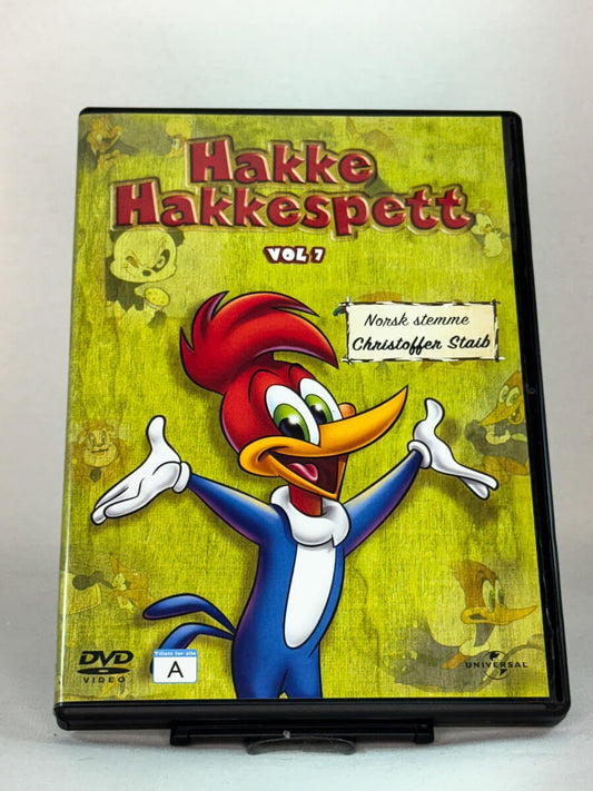 Forside av DVD-cover til Hakke Hakkespett Vol. 7 – klassiske episoder med den rampete fuglen, norsk stemme av Christoffer Staib, brukt DVD hos Brukbar Film.