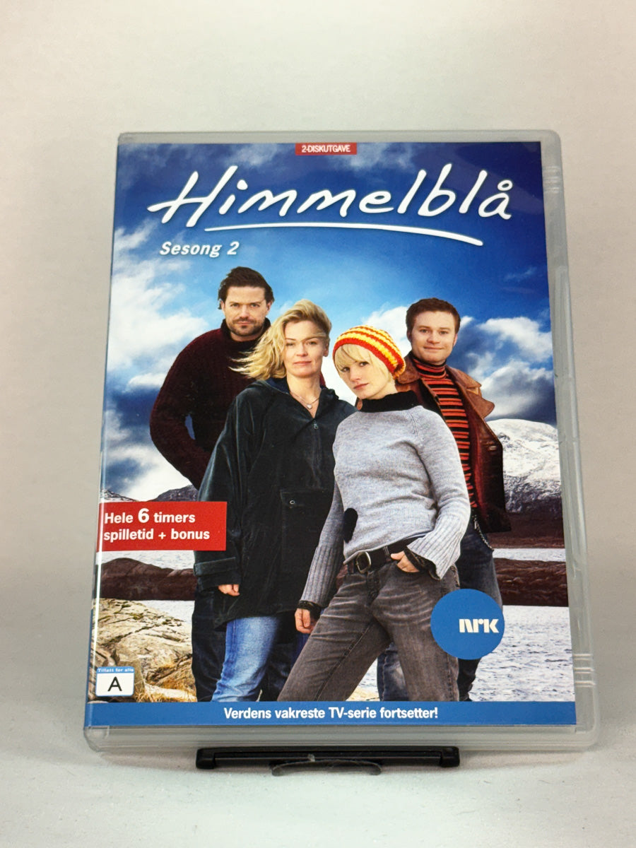 Forside av DVD-cover til «Himmelblå – Sesong 2» – fortsettelsen av dramaserien fra NRK, utgitt på brukt DVD hos Brukbar Film.