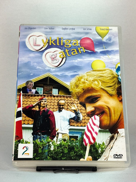 Forside av DVD-cover til Lyckliga gatan – norsk komiserie med Jon Øigarden, Linn Skåber, Dagfinn Lyngbø og Jon Schau, brukt DVD hos Brukbar Film.
