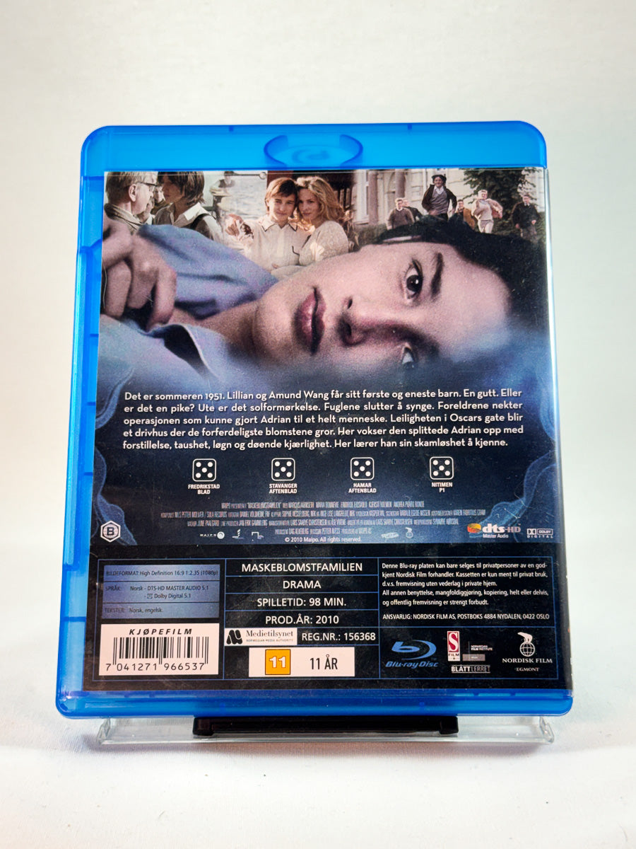 Bakside av Blu-ray-cover til Maskeblomstfamilien, brukt Blu-ray hos Brukbar Film