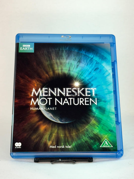 Forside av Blu-ray-cover til Mennesket mot naturen (Human Planet) – BBC Earths dokumentarserie om forholdet mellom mennesker og natur, med norsk tale, brukt Blu-ray hos Brukbar Film.