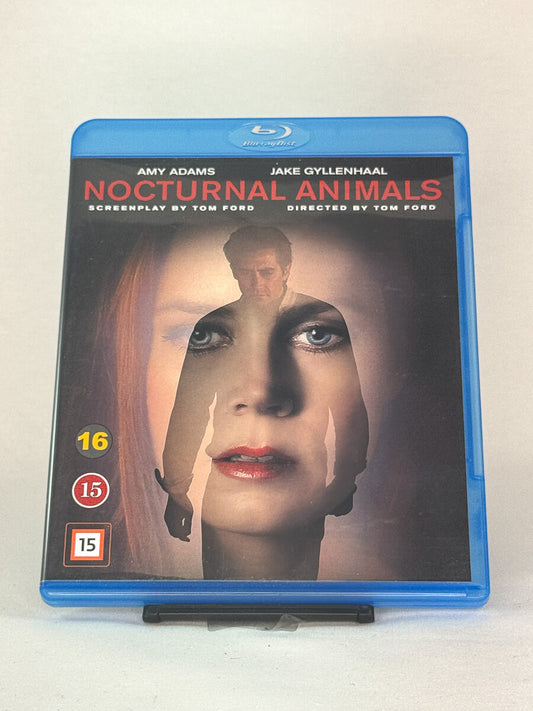 Forside av Blu-ray-cover til Nocturnal Animals med Amy Adams og Jake Gyllenhaal – mørkt og elegant thrillerdrama regissert av Tom Ford, brukt Blu-ray hos Brukbar Film.