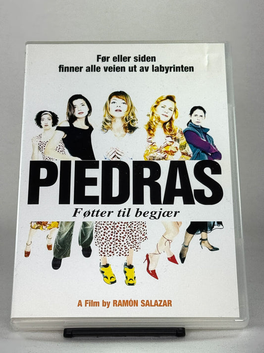 Forside av DVD-cover for Piedras – Føtter til begjær, et spansk ensembledrama; brukt DVD-film og autentisk cover hos Brukbar Film.