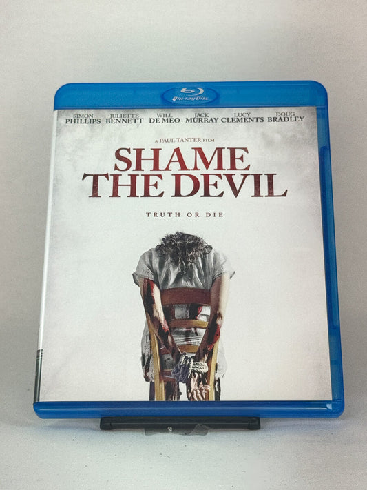 Forside av Blu-ray-cover til Shame the Devil – intens britisk thriller regissert av Paul Tanter, brukt film hos Brukbar Film.