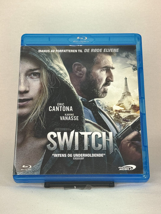 Forside av Blu-ray-cover til Switch – fransk actionthriller med Éric Cantona og Karine Vanasse, brukt film hos Brukbar Film.