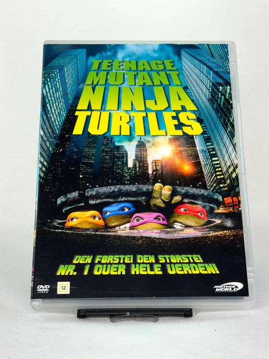 Forside av DVD-cover til Teenage Mutant Ninja Turtles – brukt action/eventyrfilm på DVD for barn og familie, tilgjengelig hos Brukbar Film