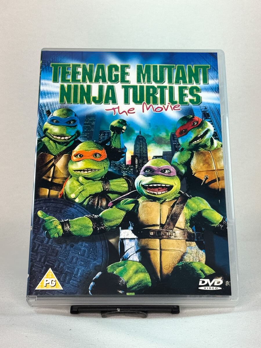 Forside av DVD-cover til Teenage Mutant Ninja Turtles: The Movie – klassisk actionkomedie fra 90-tallet med skilpaddeheltene, brukt film fra Brukbar Film
