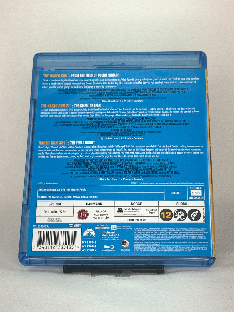 Blu-ray-cover-bakside til filmen The Naked Gun Trilogy – Brukt Blu-ray fra nettbutikken Brukbar Film