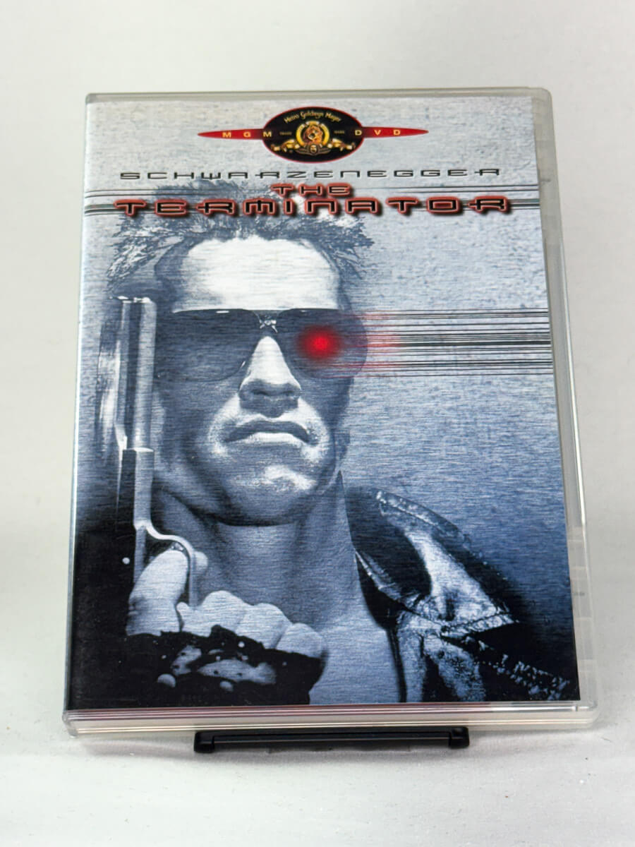 Forside av DVD-cover til The Terminator med Arnold Schwarzenegger – banebrytende sci-fi actionklassiker regissert av James Cameron, brukt DVD fra Brukbar Film