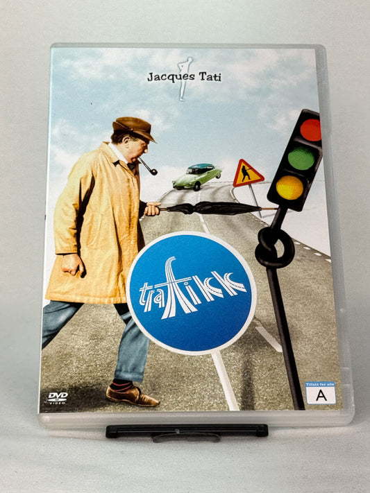 Forside av DVD-cover til Trafikk av Jacques Tati – sjarmerende satire om bilkultur og moderne kaos, brukt DVD hos Brukbar Film.