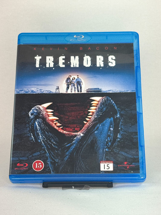 Forside av Blu-ray-cover til Tremors – kultklassiker med Kevin Bacon, brukt Blu-ray tilgjengelig hos Brukbar Film