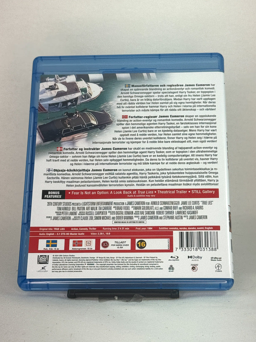 Bakside av Blu-ray-cover til True Lies – storslått actionfilm med humor, spenning og klassisk 90-tallssjarm, original brukt Blu-ray-utgave hos Brukbar Film.