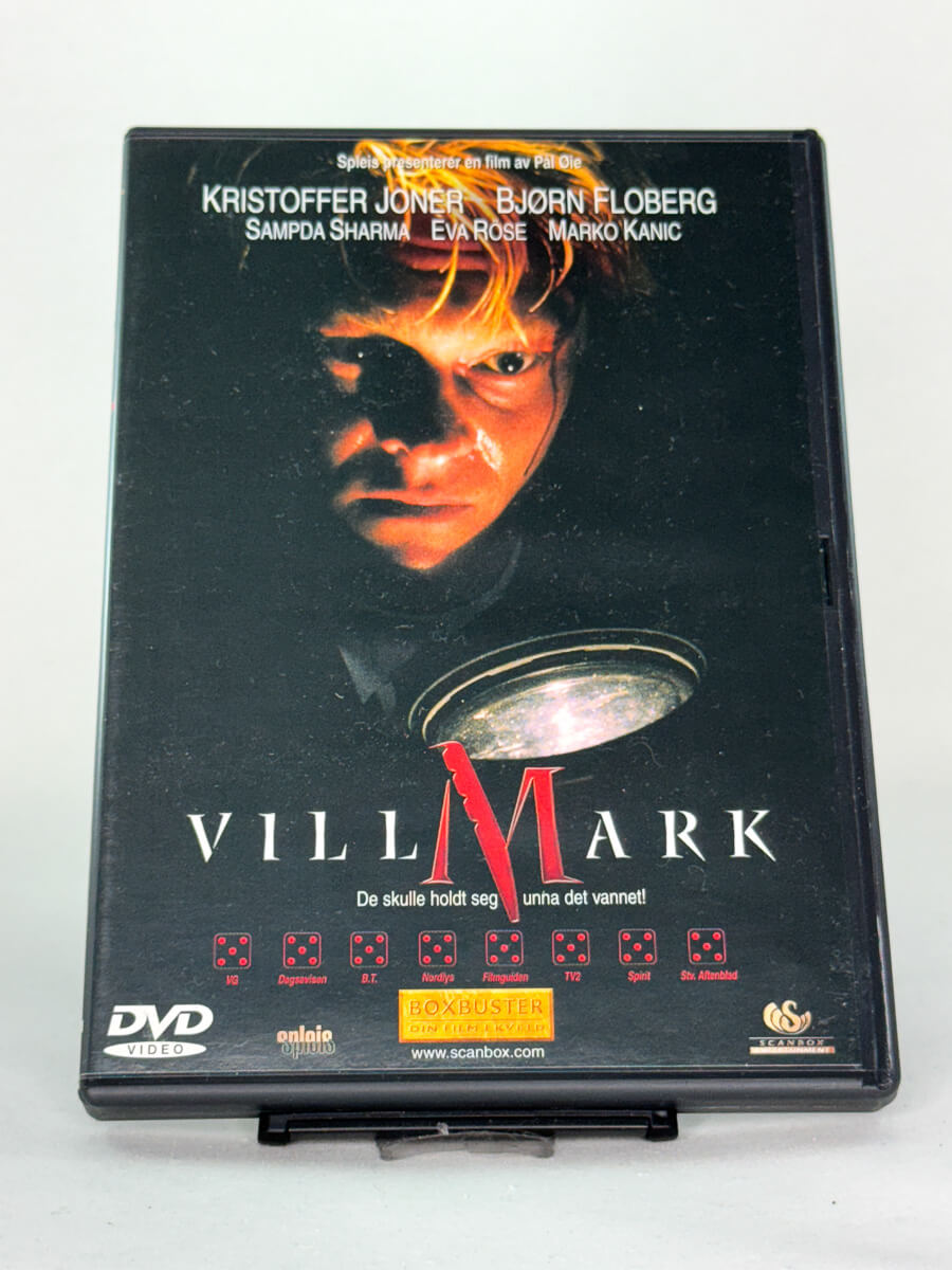 Forside av DVD-cover til Villmark – norsk thriller av Pål Øie med Kristoffer Joner og Bjørn Floberg, kjent for intens stemning og psykologisk skrekk – brukt DVD hos Brukbar Film.